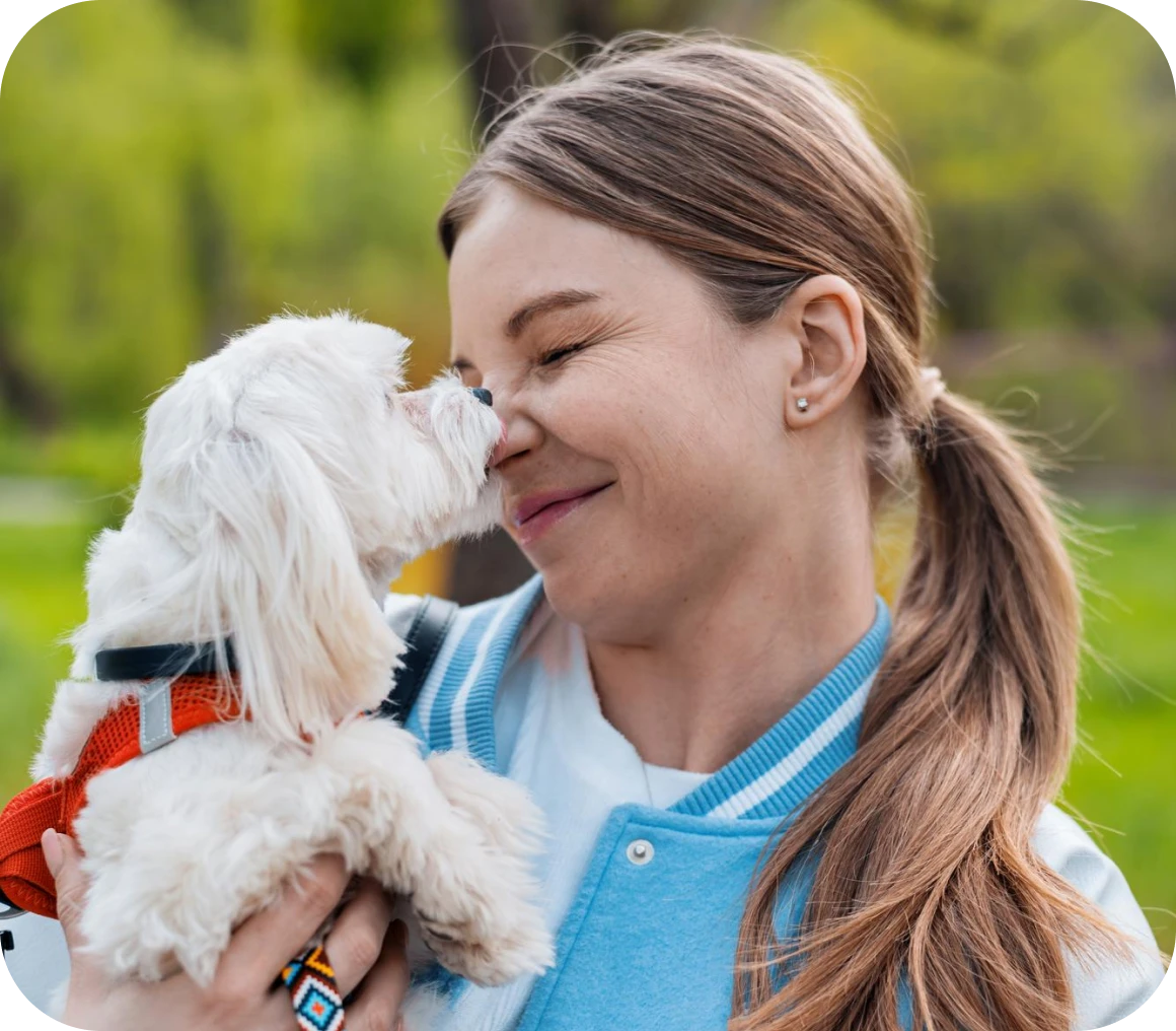 Woman smiling with fluffy white dog